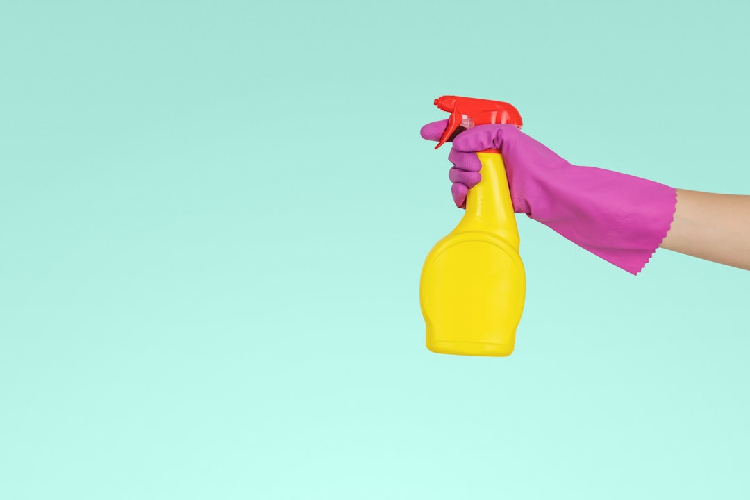 an individual holding a yellow plastic spray bottle-zmnefoi3k